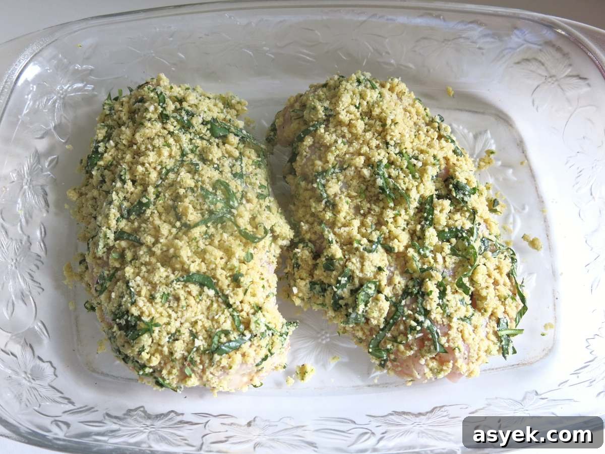 Crispy Parmesan Herb-Crusted Chicken Recipe 5 Uncooked Parmesan Herb Crusted Chicken breasts in a baking dish.