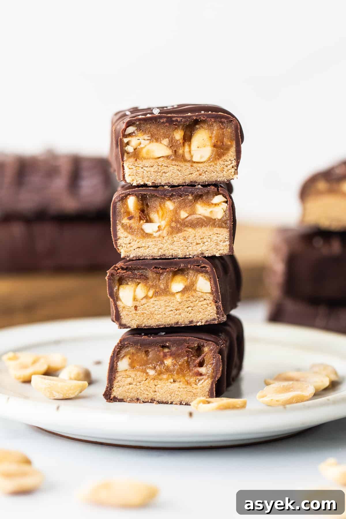 A stack of chocolate peanut butter bars on a plate.