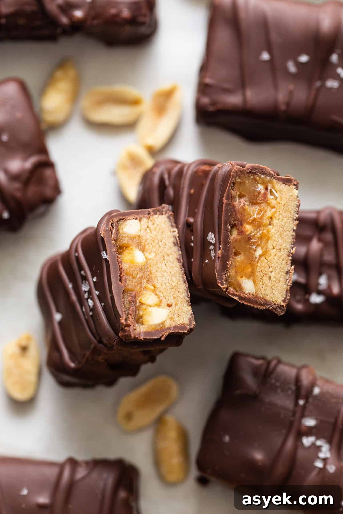 Chocolate peanut butter bars with peanuts on top.
