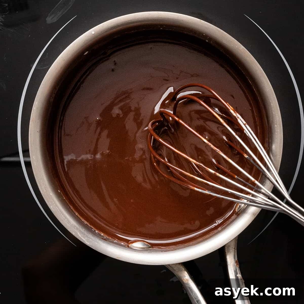 Moist Chocolate Zucchini Cake Recipe 7 whisking ganache in a small saucepan