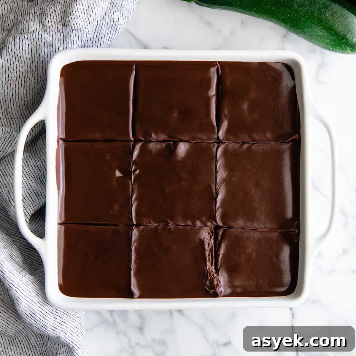 Moist Chocolate Zucchini Cake Recipe 9 overhead view of a square chocolate zucchini cake cut into 9 pieces