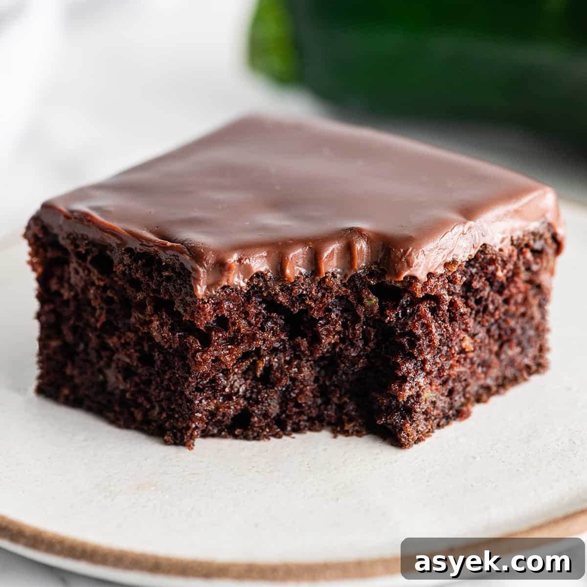 Chocolate Zucchini Cake front view of a piece of chocolate zucchini cake with chocolate ganache