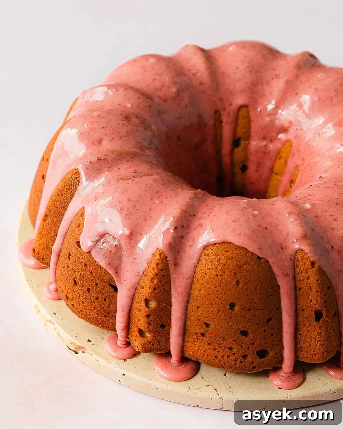 Strawberry pound cake is a buttery, moist, dense and tender pound cake made with fresh strawberries. Top with this pound cake with fresh strawberries with a sweet and creamy fresh strawberry icing. Enjoy this easy to make, strawberry filled classic pound cake for breakfast, brunch or dessert.