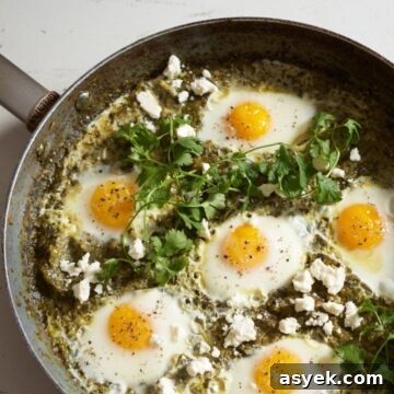 Green shakshuka topped with feta and garnished with fresh cilantro.