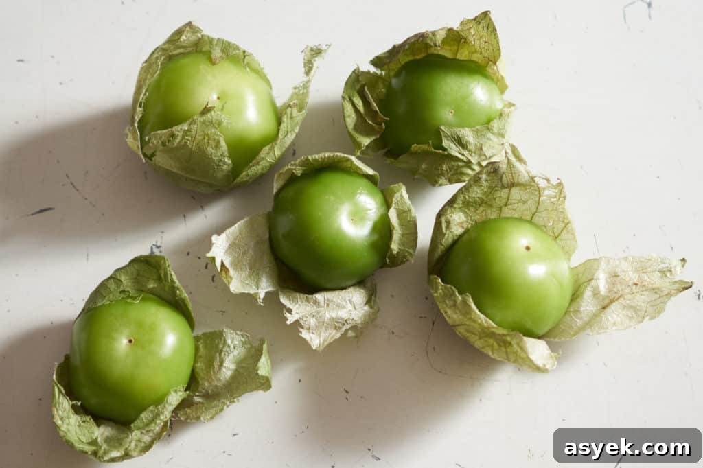 Five tomatillos in their husks.