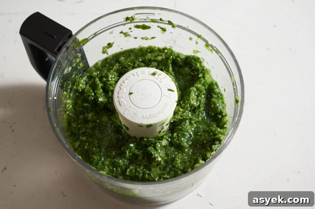Green shakshuka sauce in a food processor.