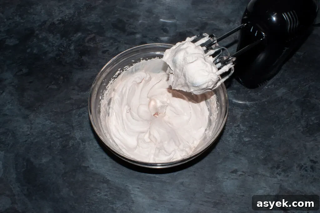 Fresh strawberry frosting in a glass bowl.