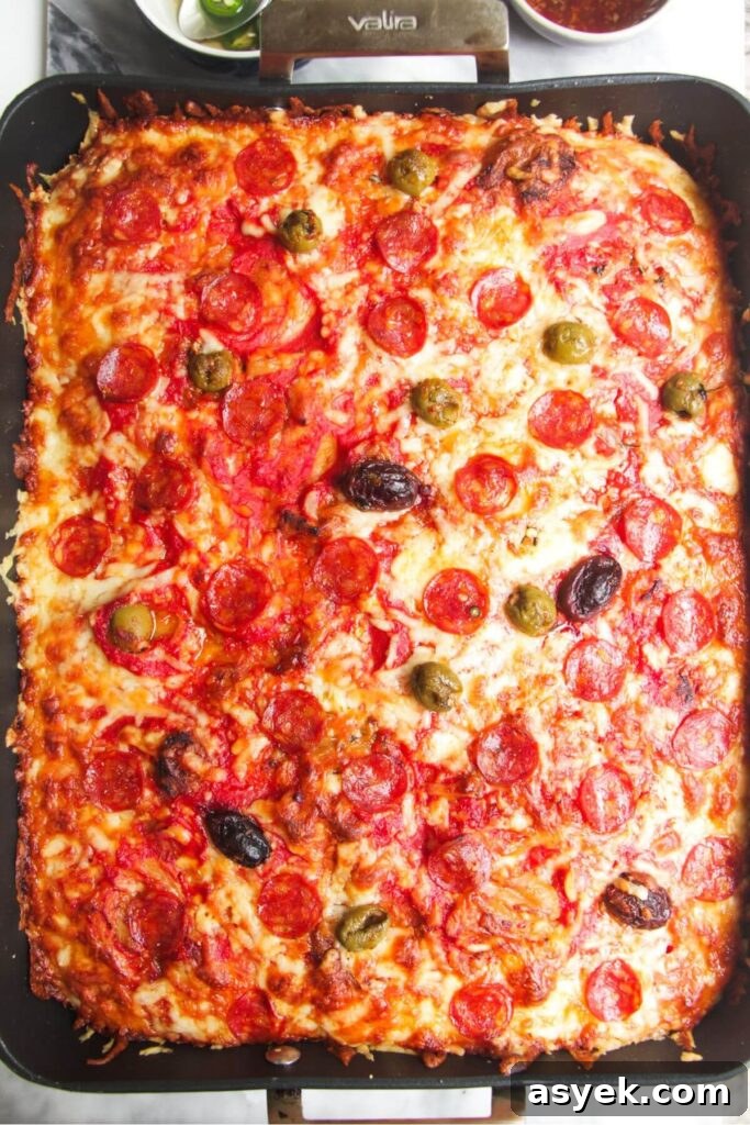 Pepperoni Focaccia Pizza Bread with Crispy Cheese Crust 12 Focaccia pizza baked and golden in a large oven dish.