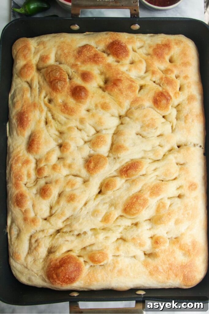 Pepperoni Focaccia Pizza Bread with Crispy Cheese Crust 9 Par-baked focaccia dough in a large oven dish.
