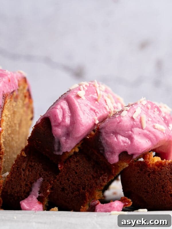 A loaf cake with vibrant pink frosting