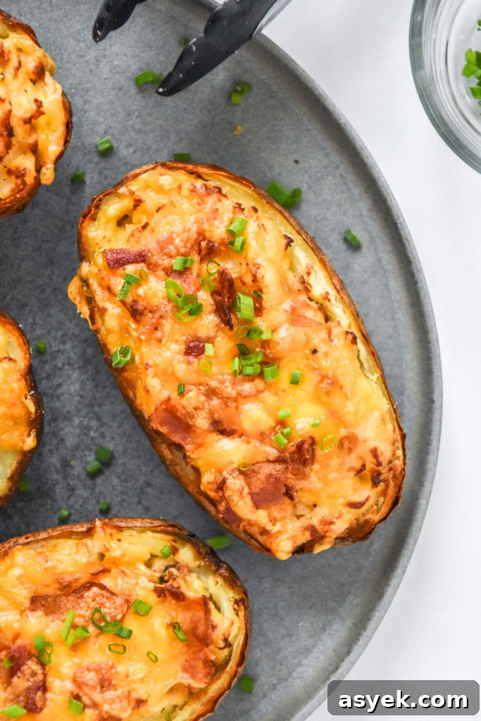 air fryer twice baked potatoes golden brown with chives on top.