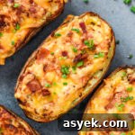 Air Fryer Twice Baked Potatoes with cheese, bacon bits and chives on top.