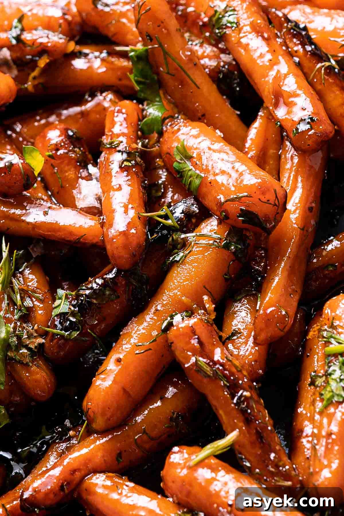 honey orange glazed carrots with herb garnish