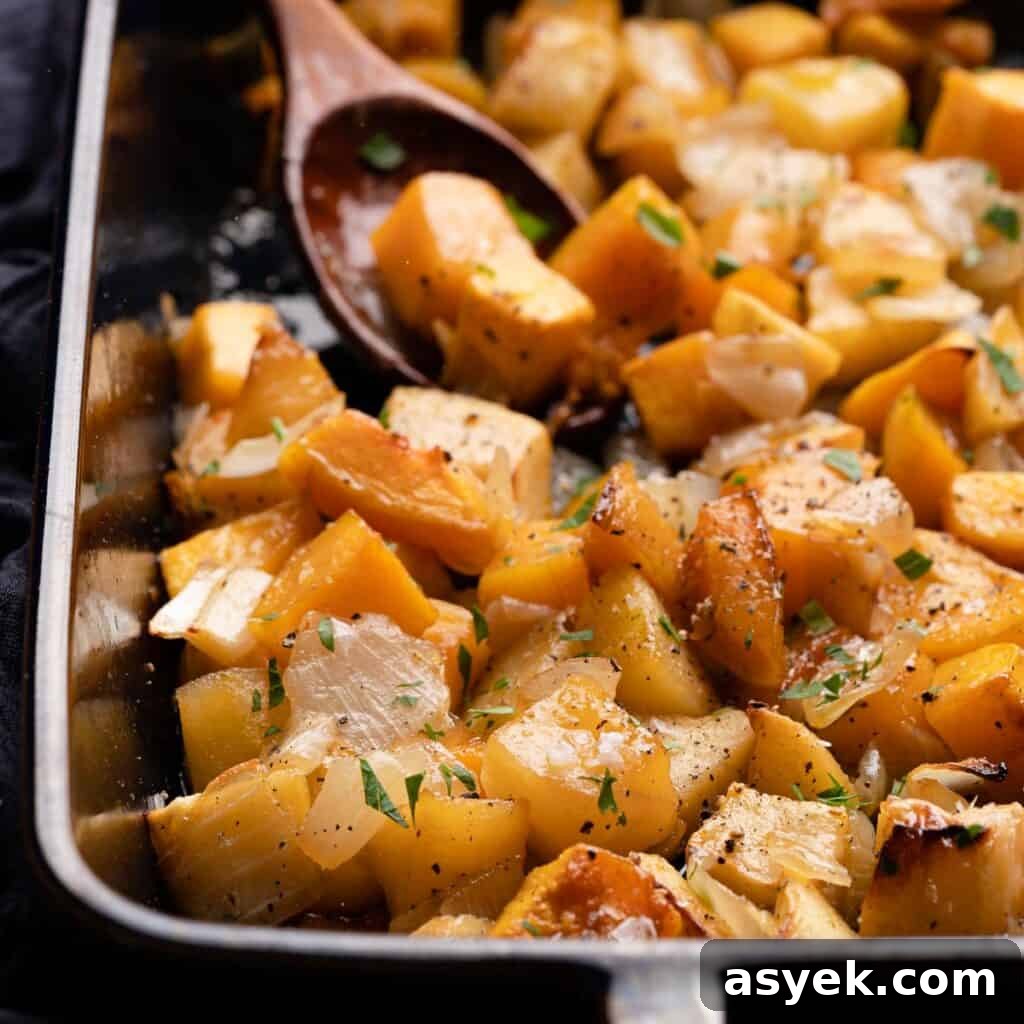 maple glazed squash and apples in pan with spoon