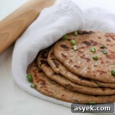 Soft Whole Wheat Rye Flatbread Recipe with Scallions 10 Flatbreads stacked on a towel next to a rolling pin