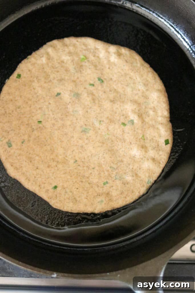 Soft Whole Wheat Rye Flatbread Recipe with Scallions 5 flatbread cooking in a cast iron skillet