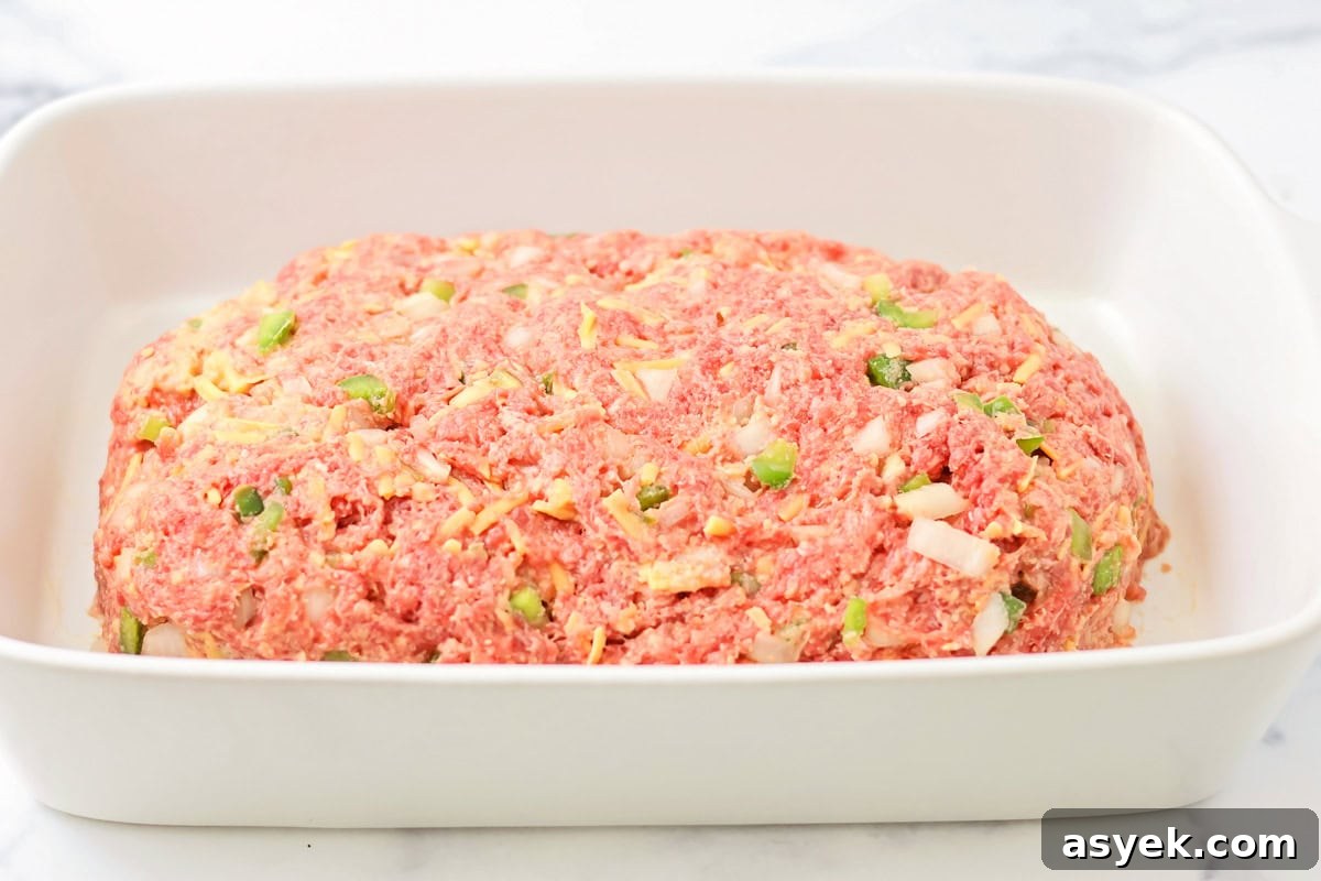 A shaped loaf of meat in a baking dish.