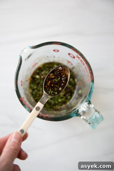 Balsamic Pork Loin Marinade for Grilling or Roasting 12 balsamic pork tenderloin marinade in a cup measure with spoon
