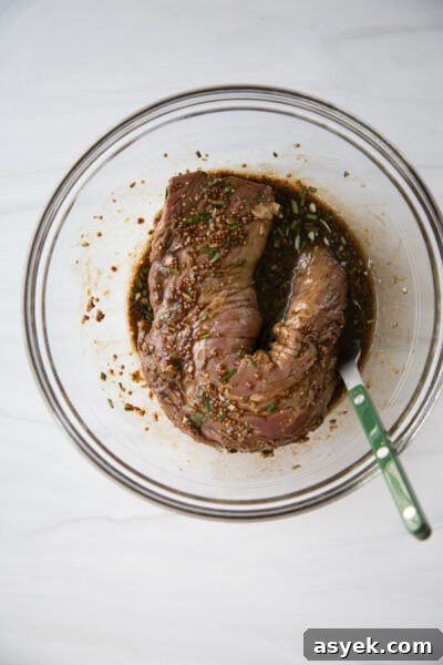 Balsamic Pork Loin Marinade for Grilling or Roasting 14 pork tenderloin marinated overnight in balsamic glaze in a bowl