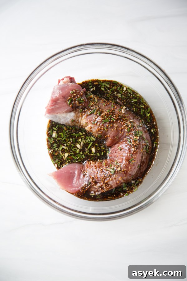 Balsamic Pork Loin Marinade for Grilling or Roasting 15 pork tenderloin marinating in balsamic glaze in a bowl