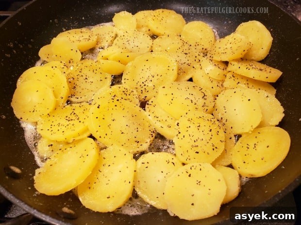 Cheesy Skillet Potatoes - The Grateful Girl Cooks! Seasoned, round potato slices are cooked in butter in a skillet.