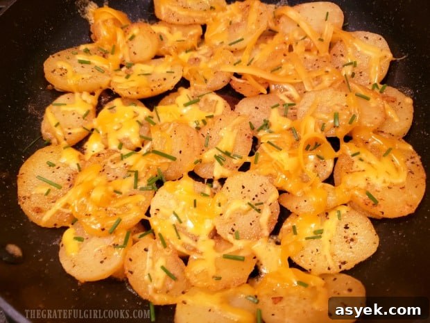 Cheesy Skillet Potatoes - The Grateful Girl Cooks! Cheesy skillet potatoes are topped with grated cheese and chopped fresh chives.