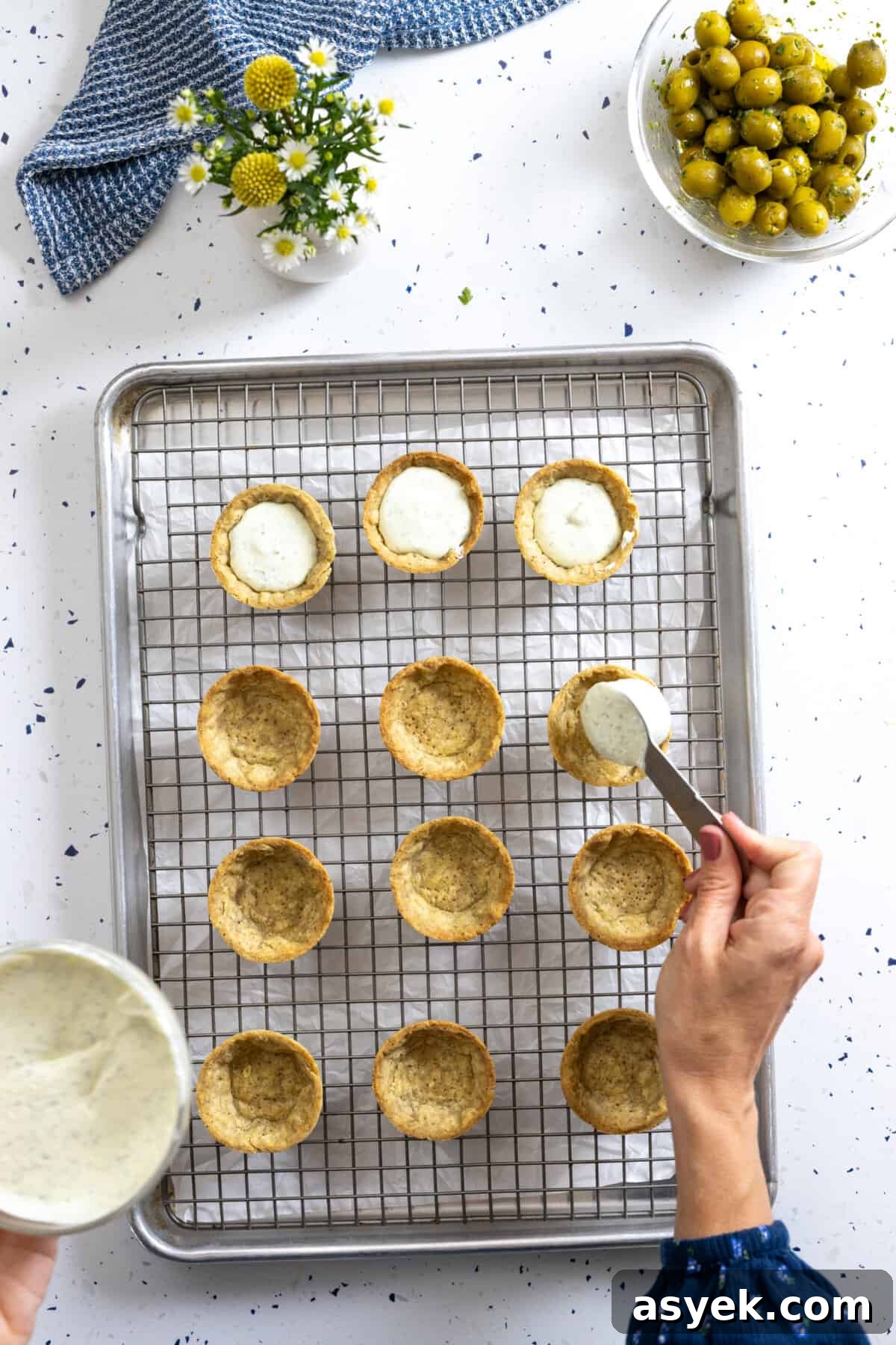 Filling savory tartlet shells with goat cheese filling