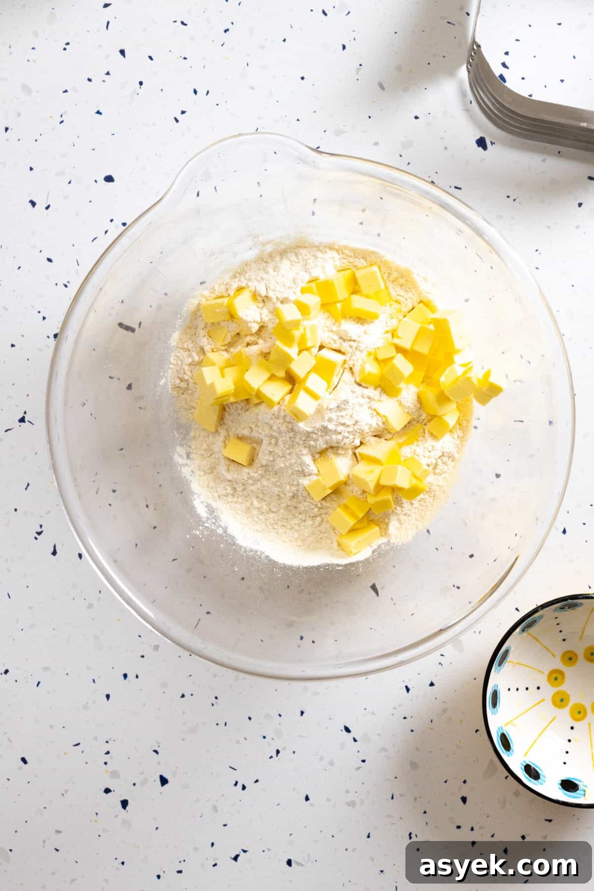 Adding cold cubed butter to dry ingredients