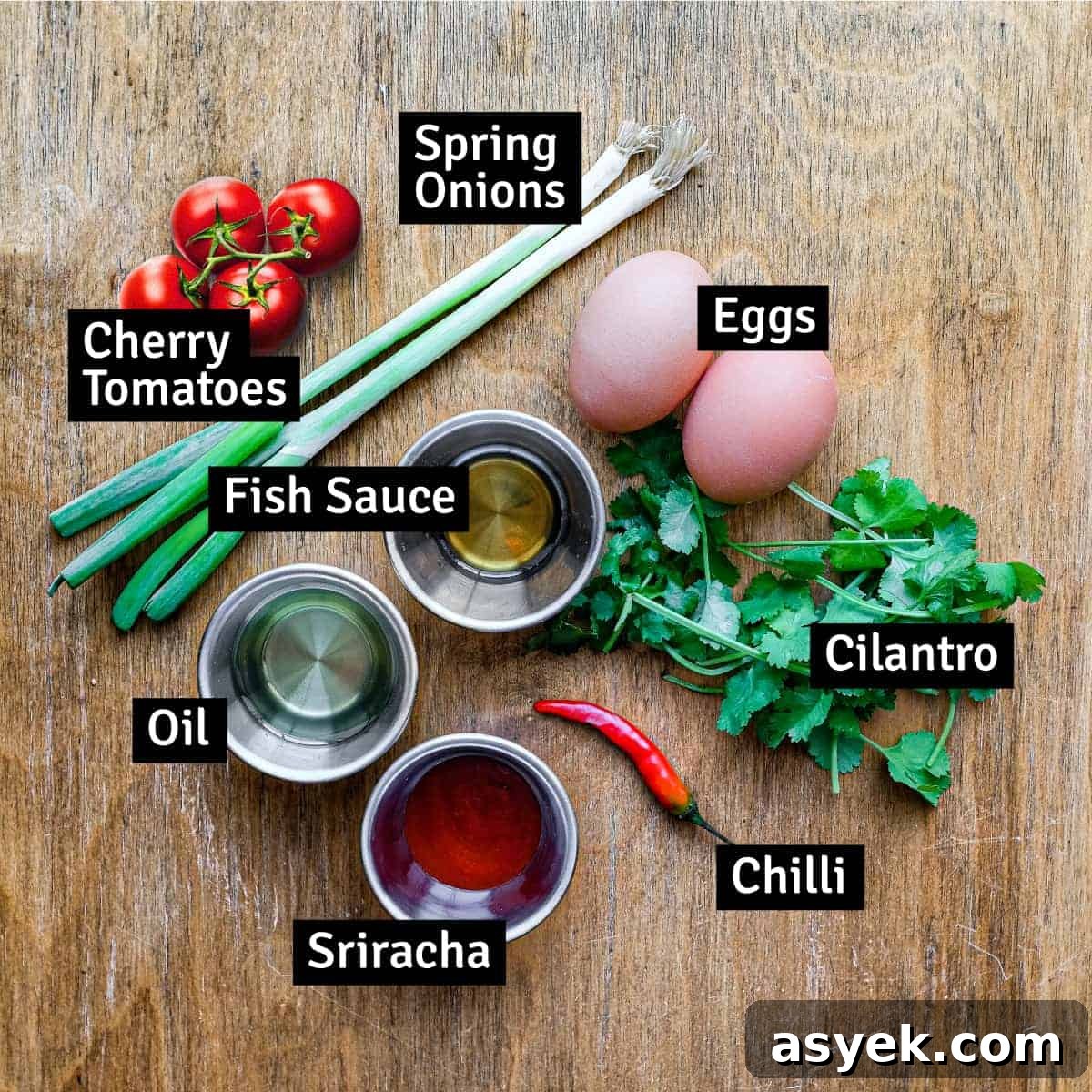 Thai Omelette (Kai Jeow) | cookeatworld.com The ingredients for the Thai omelette: eggs, fish sauce, spring onion, oil, chilli, tomatoes, cilantro.