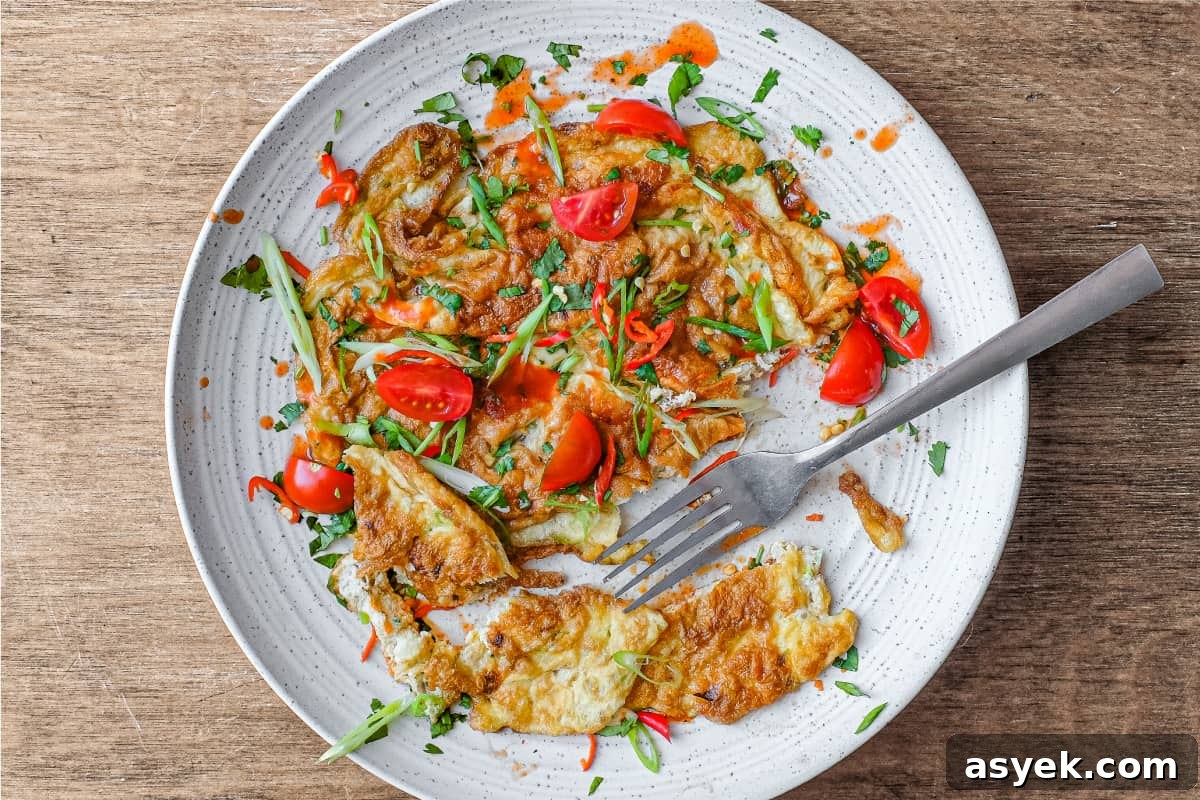 A plate of Thai Omelette with a fork.