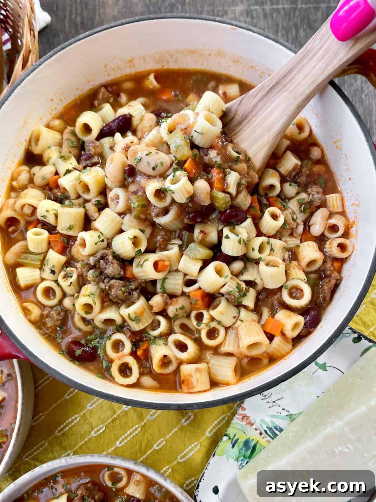 Pasta Fagioli in Dutch oven with wooden ladle.