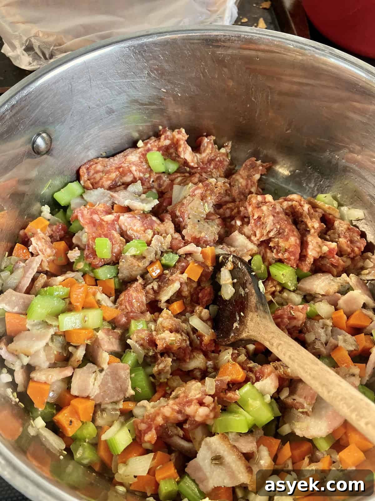 Sauteed vegetables and sausage in stockpot.