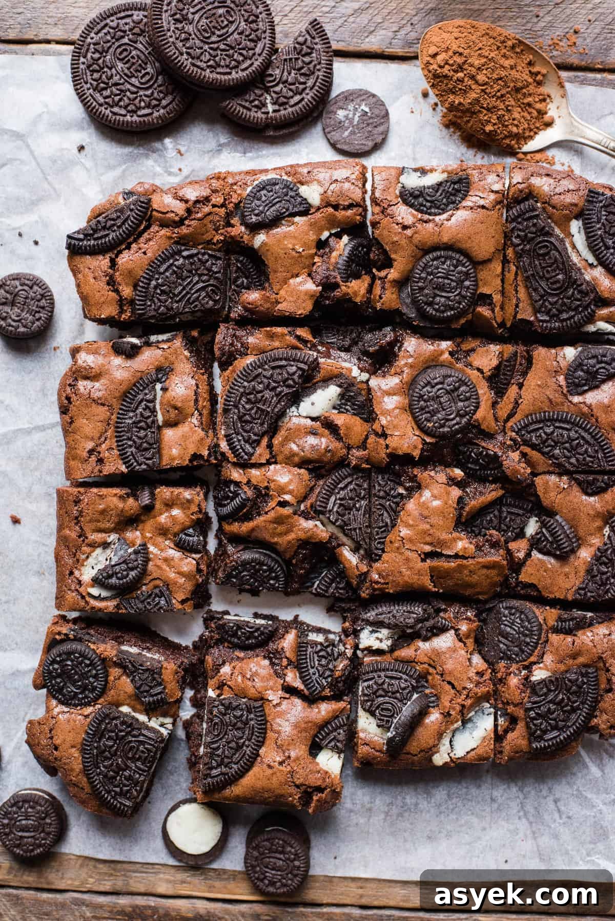 oreo brownies cut into squares and arranged on white parchment paper