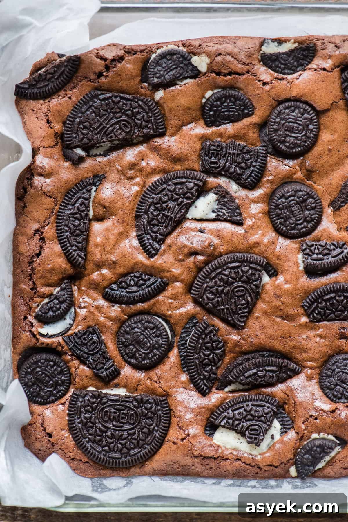 whole pan of oreo brownies in glass dish with white parchment paper
