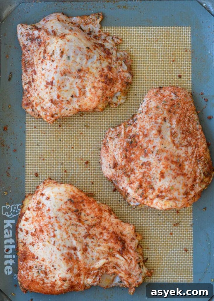 Rubbing seasoning into chicken thighs