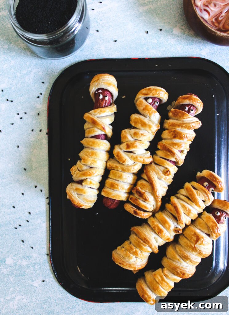 Mummy Hot Dogs on black plate