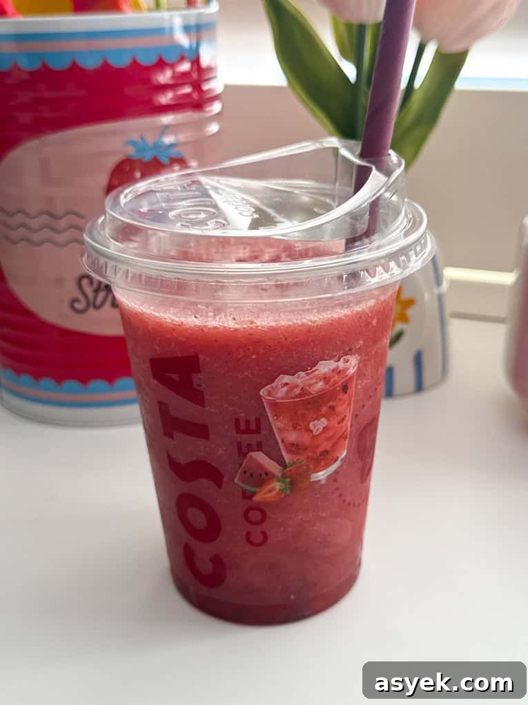 Strawberry, Watermelon & Mint Refresher served in a clear Costa plastic cup with a straw.