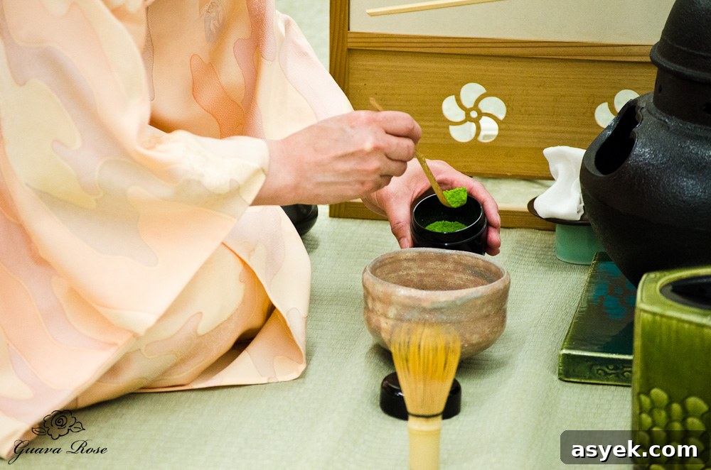 Scooping matcha with tea scoop into bowl during teaceremony