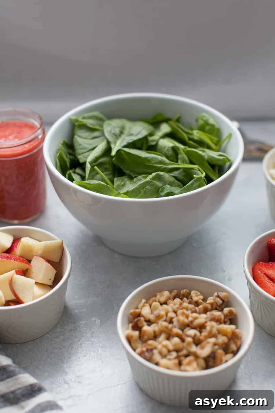 Strawberry Spinach Salad with Balsamic Vinaigrette 5 Bowl of strawberry vinaigrette dressing next to fresh strawberries.
