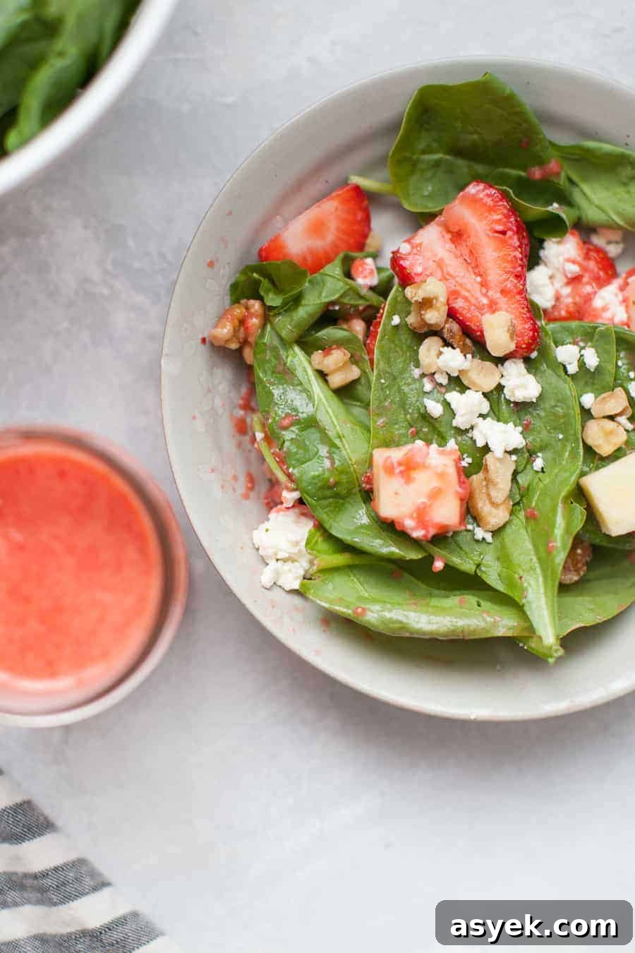Strawberry Spinach Salad with Balsamic Vinaigrette 6 Strawberry spinach salad plated with a drizzle of vinaigrette.