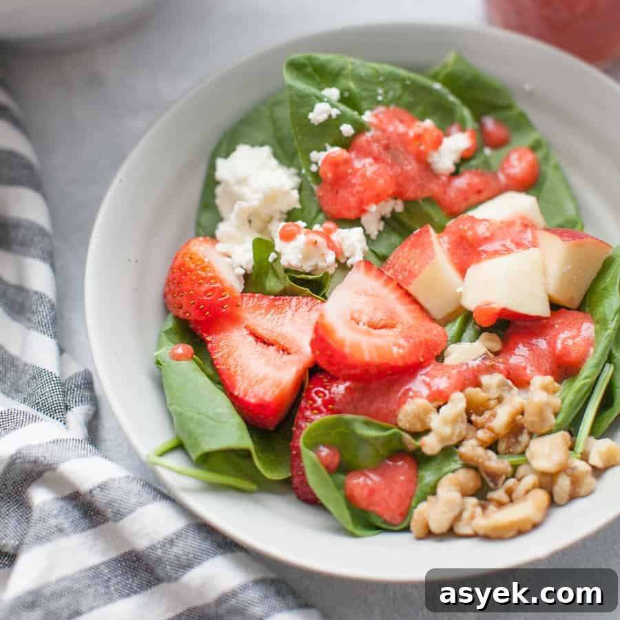 Strawberry Spinach Salad with Balsamic Vinaigrette 9 Square image of strawberry spinach salad with visible layers of ingredients.