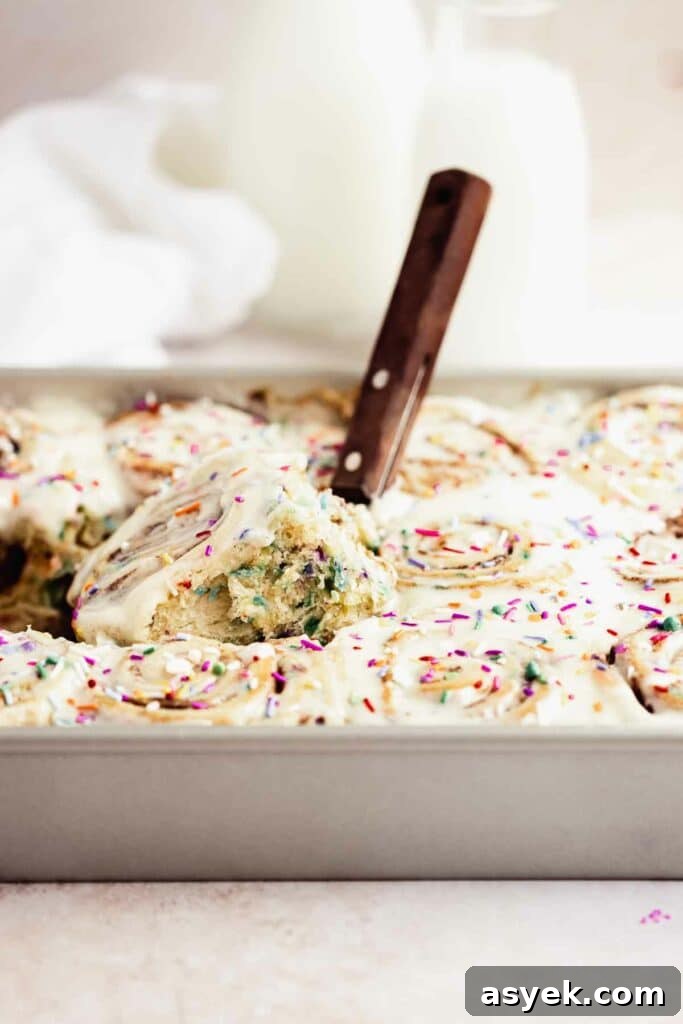 side peak at funfetti cinnamon roll with frosting