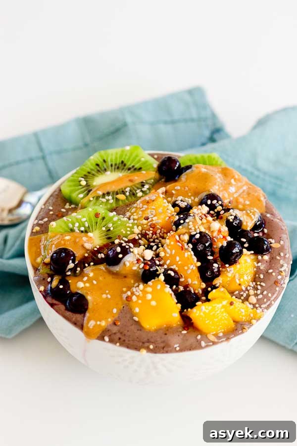 With summer quickly approaching, this superfood smoothie bowl will keep you cool and fueled on the sunniest days. Wild blueberries, spinach, avocado, and flaxmilk combine to form a creamy, antioxidant-packed bowl that is vegan and gluten-free! Slices of fresh kiwi and a drizzle of almond butter make this smoothie bowl practically irresistible.