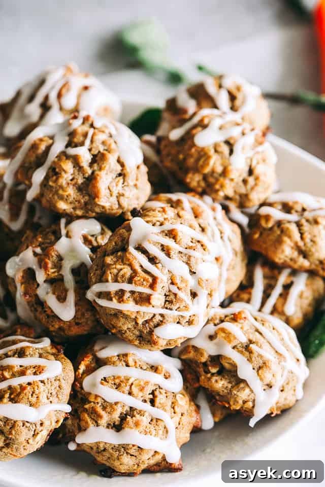 Chewy Carrot Cake Cookies with Cream Cheese Frosting 4 Carrot cake cookies stacked in a bowl.