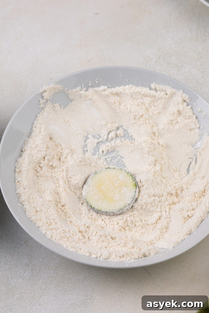 Crispy Air Fryer Zucchini Chips Recipe 6 Zucchini round dredged in flour.
