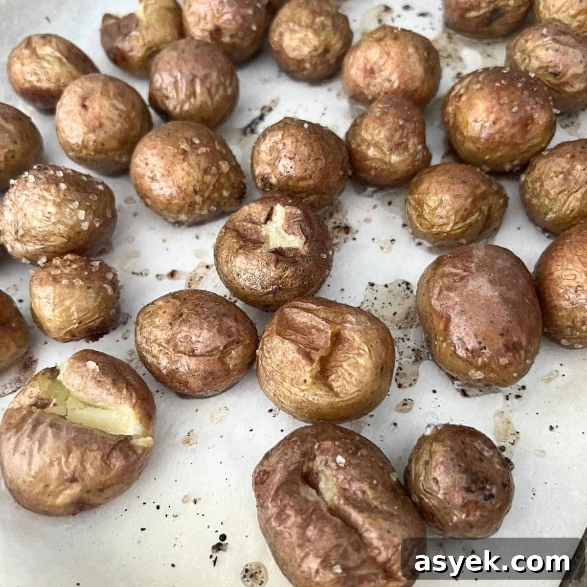 Crispy Mini Baked Potatoes with Garlic and Herbs 4 Baked potatoes on baking sheet.