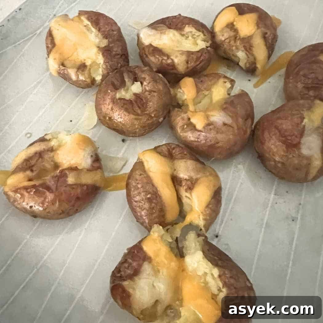 Crispy Mini Baked Potatoes with Garlic and Herbs 5 Melted cheese on baked potatoes.
