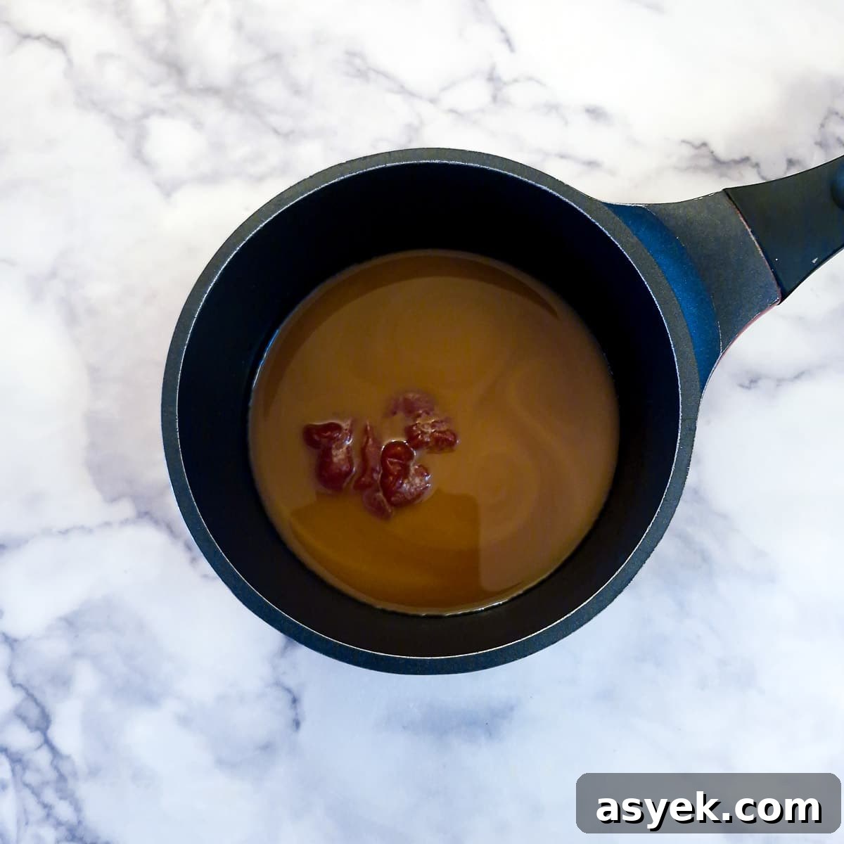 Sweet and sour sauce ingredients in a saucepan.