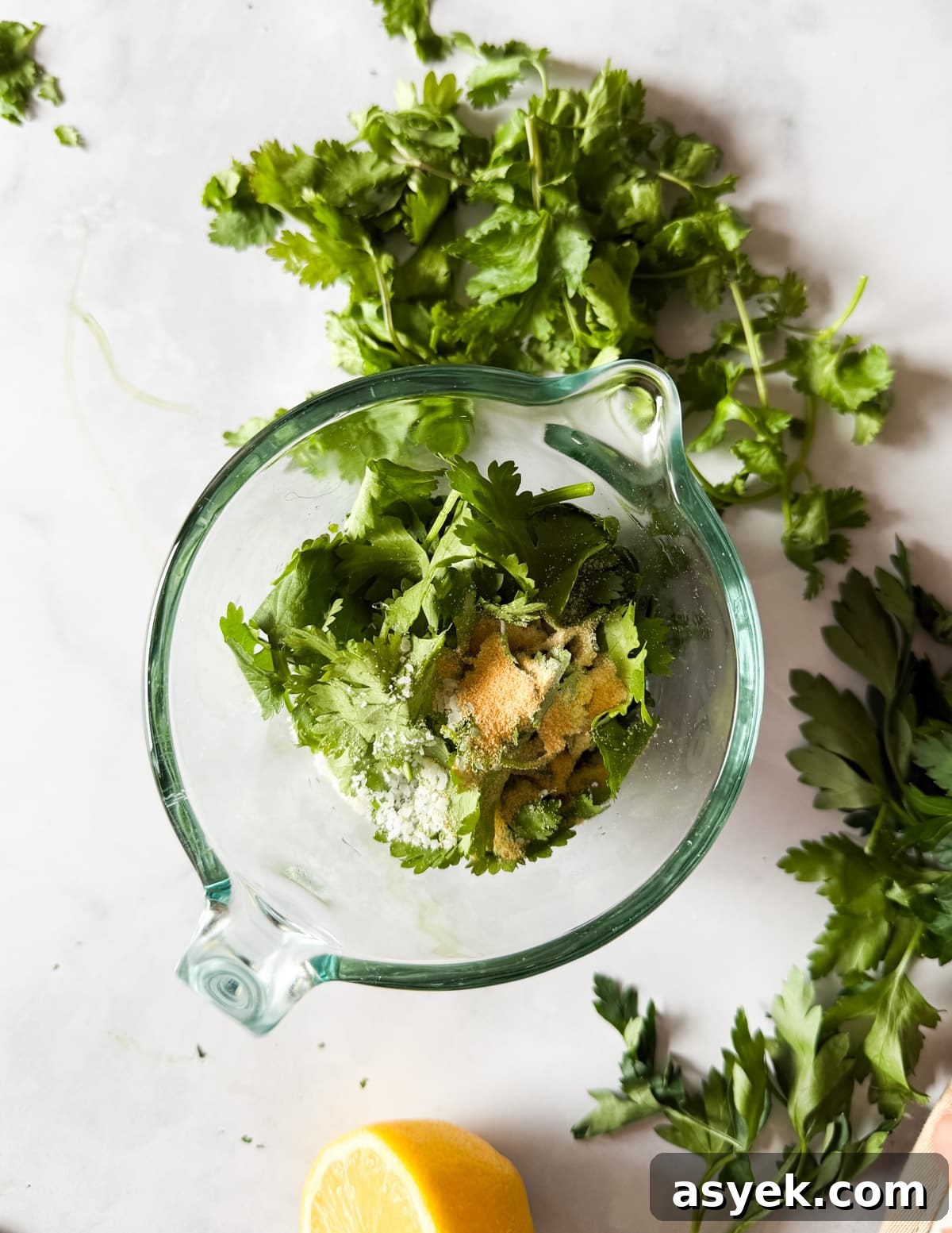 herbs, salt, spices, olive oil, and lemon juice in a jar. 