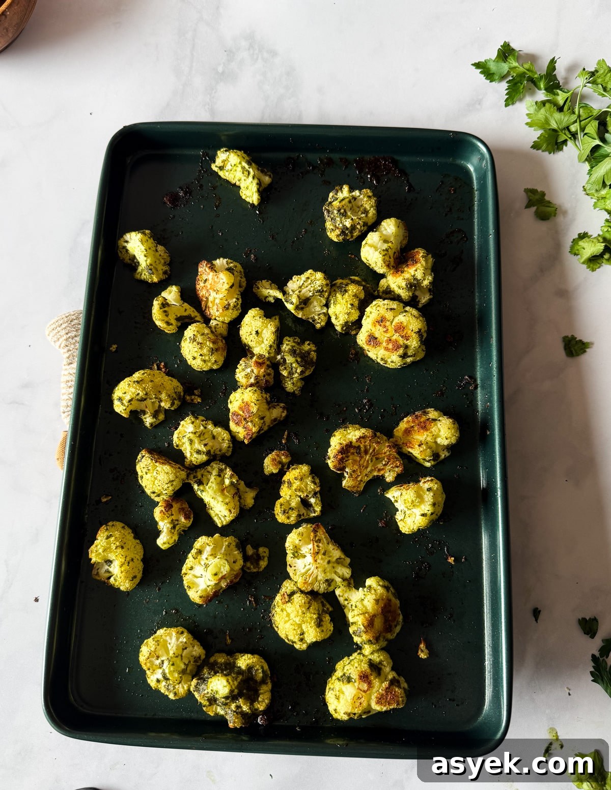 herb roasted cauliflower florets on a sheet pan. 